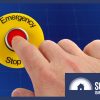 a hand pressing an emergency stop button