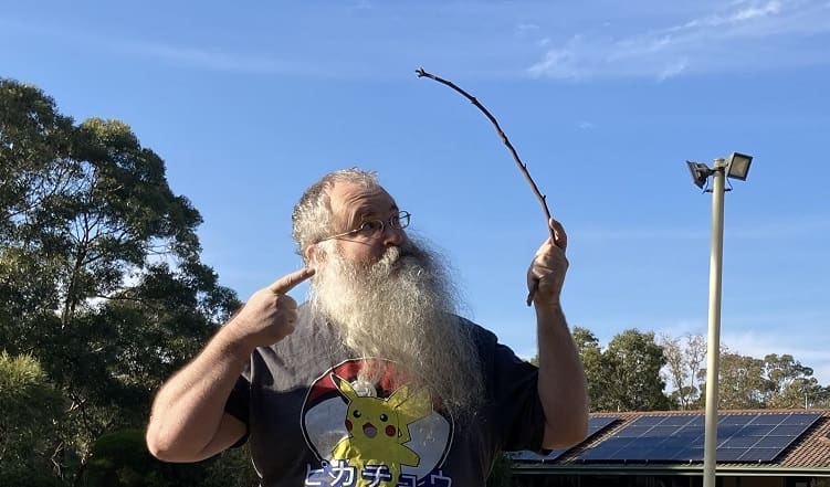 A Santa Claus impersonator holding a stick.