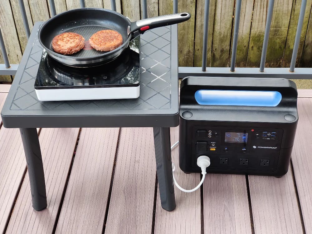 The NRGVault PV1500 portable powerstation powering a portable induction cooktop