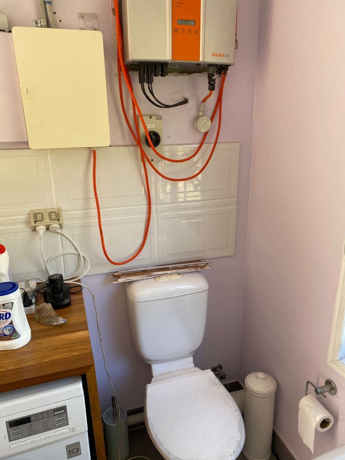 Solar inverter installed above a toilet