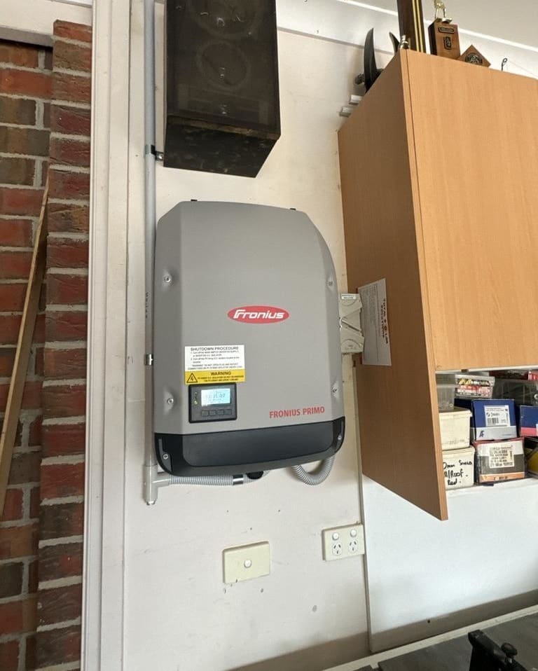 A Fronius Primo inverter mounted to the wall.