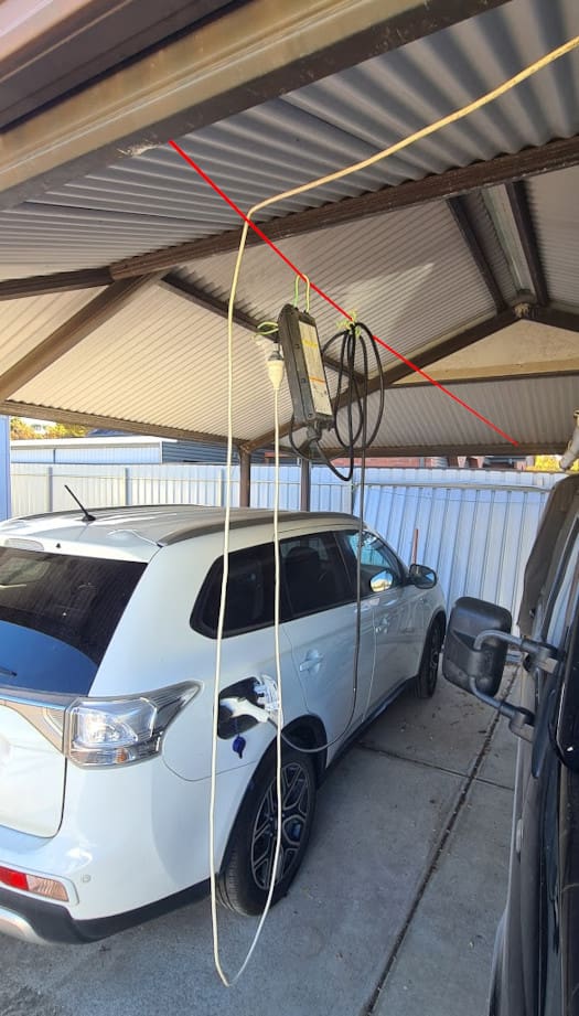 EV charger hanging in a car port