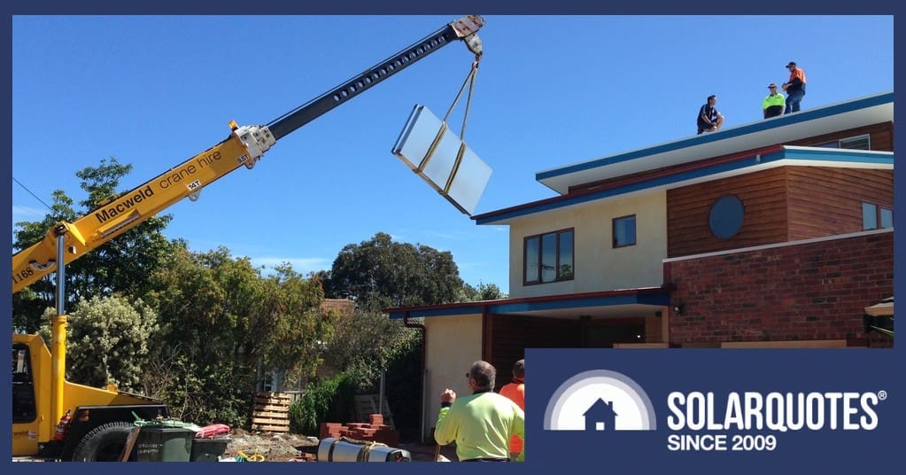 A crane hoists a solar thermal panel