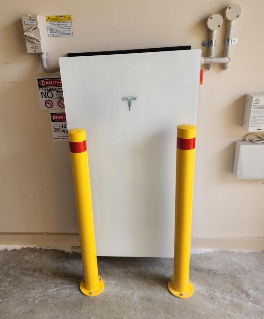 A Tesla Powerwall 3 installed by Goliath Solar in South Australia with yellow bollards.